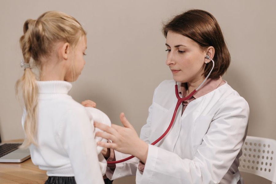 Doctor examining a child with a stethoscope